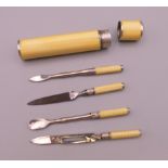 A 900 silver and yellow enamel manicure set. 7 cm high.