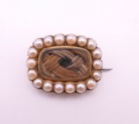 A George III seed pearl and hair plait mourning brooch, inscribed to reverse. 1.5 x 2 cm.