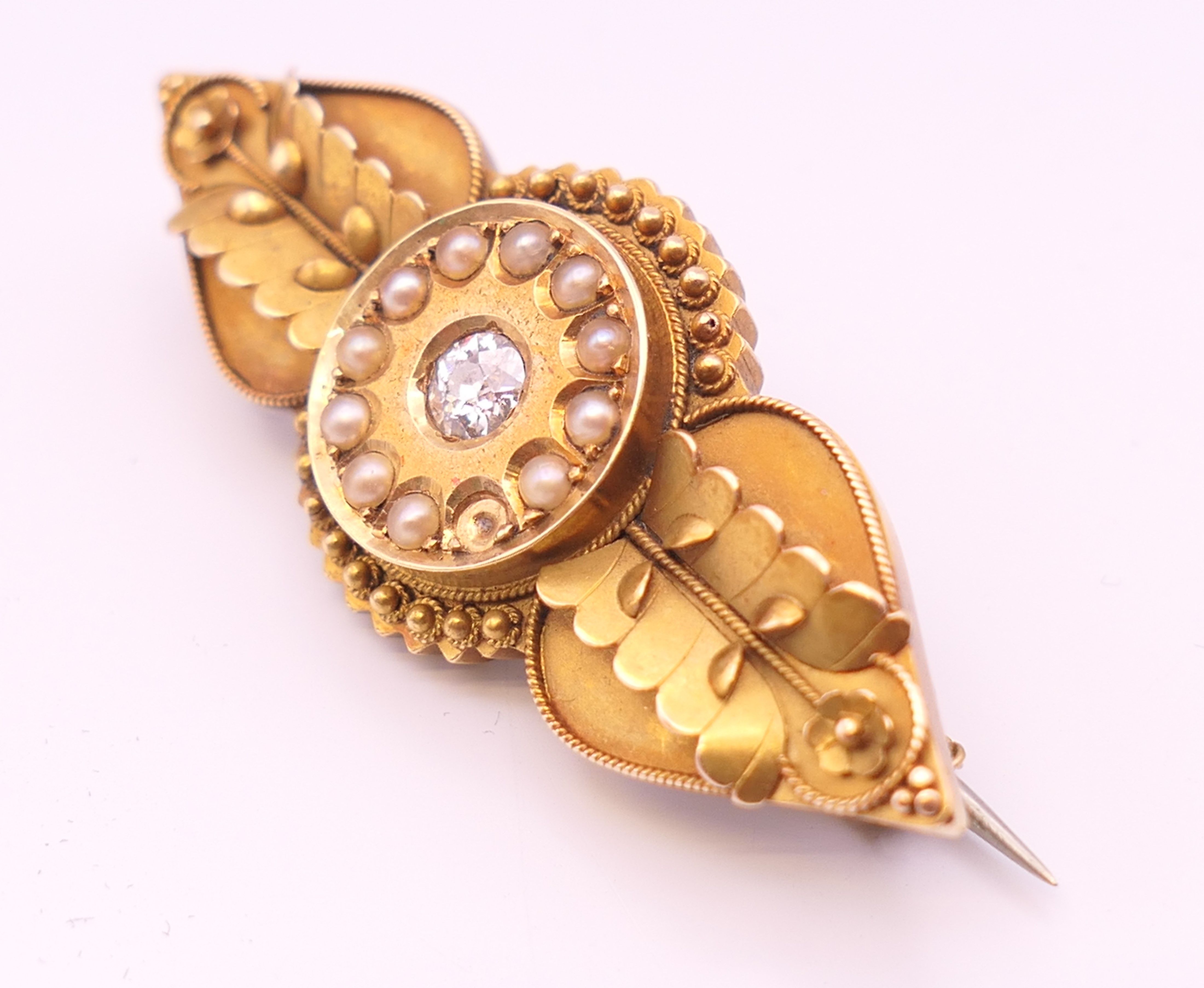 A Victorian unmarked gold diamond and seed pearl brooch. 4.5 cm long. 6.4 grammes total weight. - Image 2 of 5