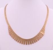 A 9 ct gold necklace. 42 cm long. 33.6 grammes.