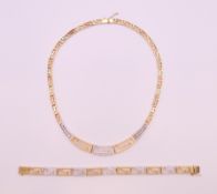 A 14 ct gold and diamond Greek key pattern necklace and bracelet. Bracelet 19.