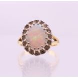 An 18 ct gold, opal and diamond ring. Ring size M.