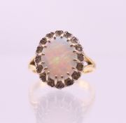 An 18 ct gold, opal and diamond ring. Ring size M.