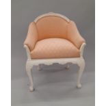 A pink upholstered white painted armchair. 61.5 cm wide.