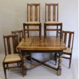 An early 20th century oak drawer leaf table and four chairs. The former 98 x 106 cm closed.