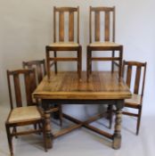 An early 20th century oak drawer leaf table and four chairs. The former 98 x 106 cm closed.