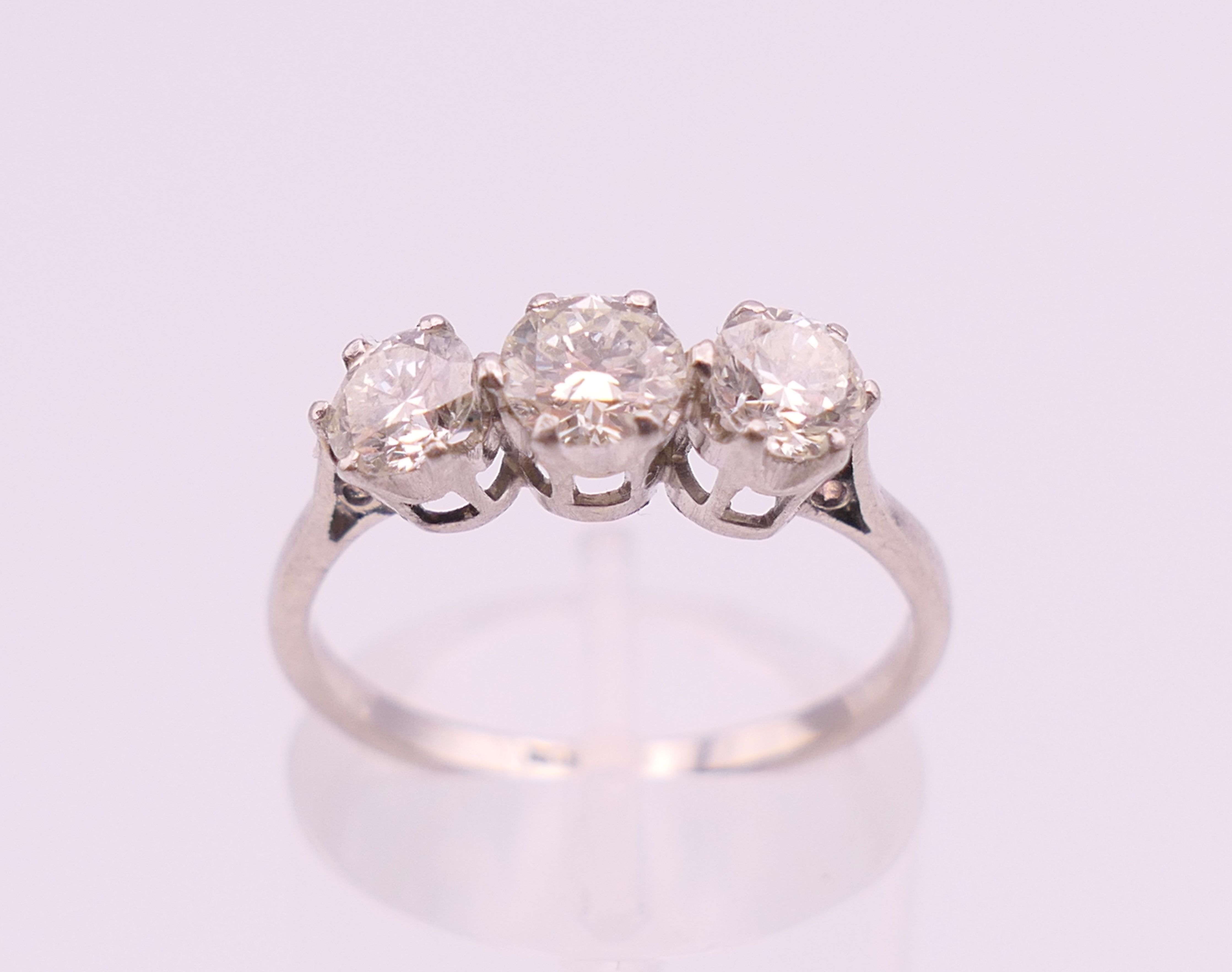 A platinum diamond trilogy ring. The total diamond weight approximately .8 carat. estimate.