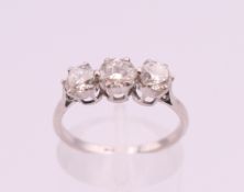A platinum diamond trilogy ring. The total diamond weight approximately .8 carat. estimate.