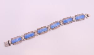 A silver and enamel bracelet. 18.5 cm long.