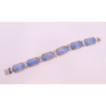 A silver and enamel bracelet. 18.5 cm long.