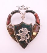 A 19th century Scottish hardstone and worked silver heart shaped brooch surmounted by a crown,