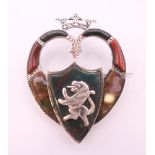 A 19th century Scottish hardstone and worked silver heart shaped brooch surmounted by a crown,