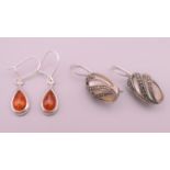 Two pairs of silver earrings. 1.5 cm high and 2 cm high excluding suspension loops.