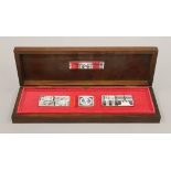 A boxed set of The Queens Silver Jubilee Standards and a Queen Elizabeth II 90th Birthday crown.