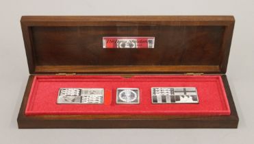 A boxed set of The Queens Silver Jubilee Standards and a Queen Elizabeth II 90th Birthday crown.