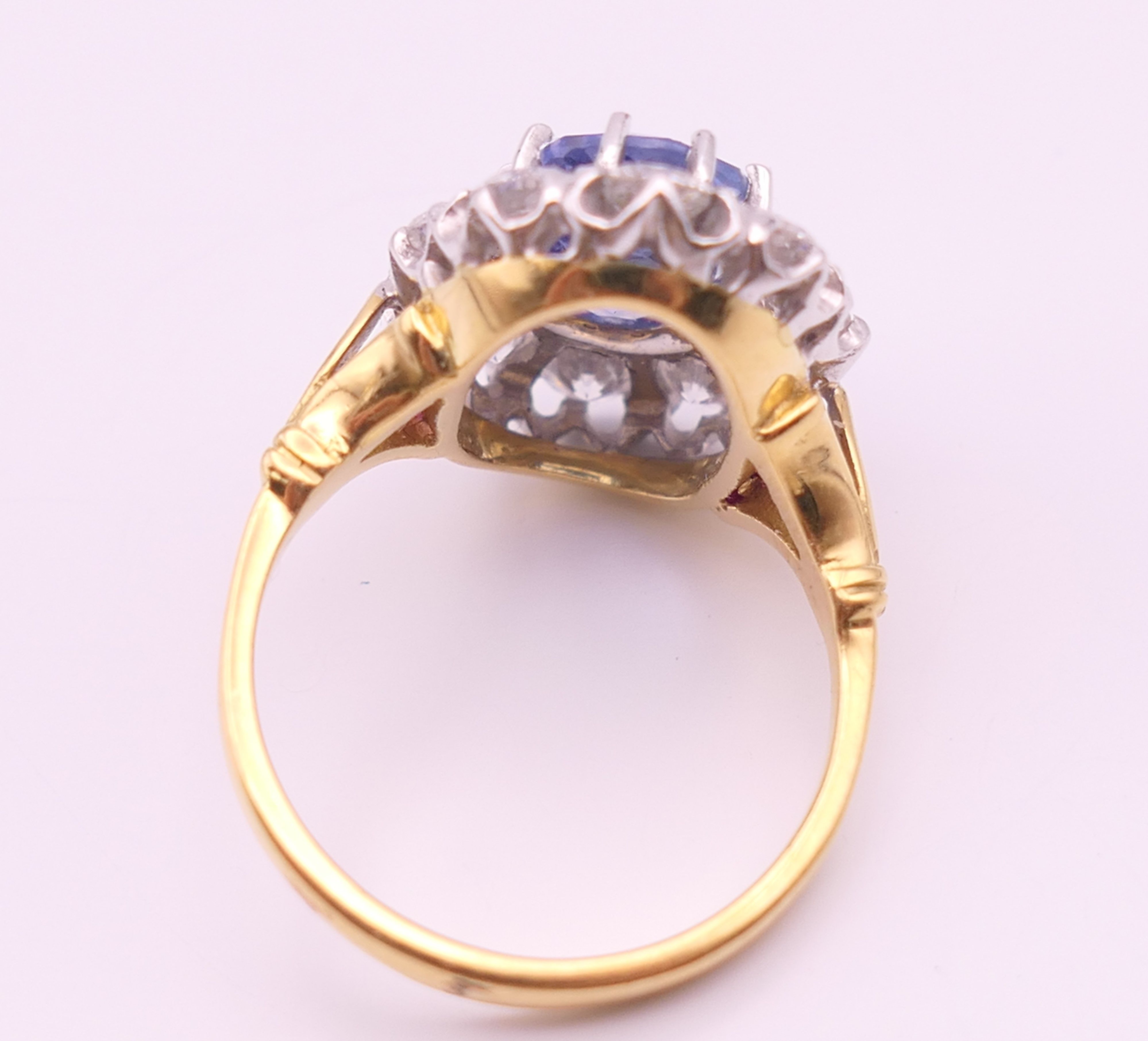 An 18 ct gold and platinum diamond and sapphire ring. - Image 3 of 9