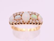 An 18 ct gold diamond and opal ring. Ring size P/Q.