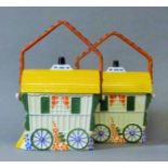 A pair of porcelain gypsy wagons form biscuit barrels.