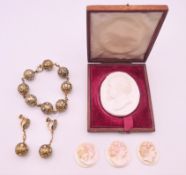 Three cameos, a bead bracelet, earrings and a boxed plaster intaglio.