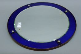 An early 20th century wall mirror and an Art Deco wall mirror. The latter 41 cm diameter.