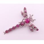 An unmarked gold, silver, diamond and ruby dragonfly form brooch. 4.5 cm high, 3.5 cm wide.