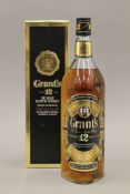 A single bottle of Grant's 12 Year Old Deluxe Scotch Whisky, boxed. 32 cm high.