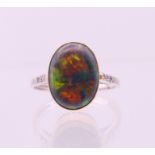 An 18 ct white and yellow gold opal ring. Ring size O.