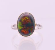 An 18 ct white and yellow gold opal ring. Ring size O.