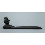 An incense stick holder surmounted with a model of Buddha. 22.5 cm long.