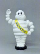 A cast iron Michelin man money box. 23 cm high.