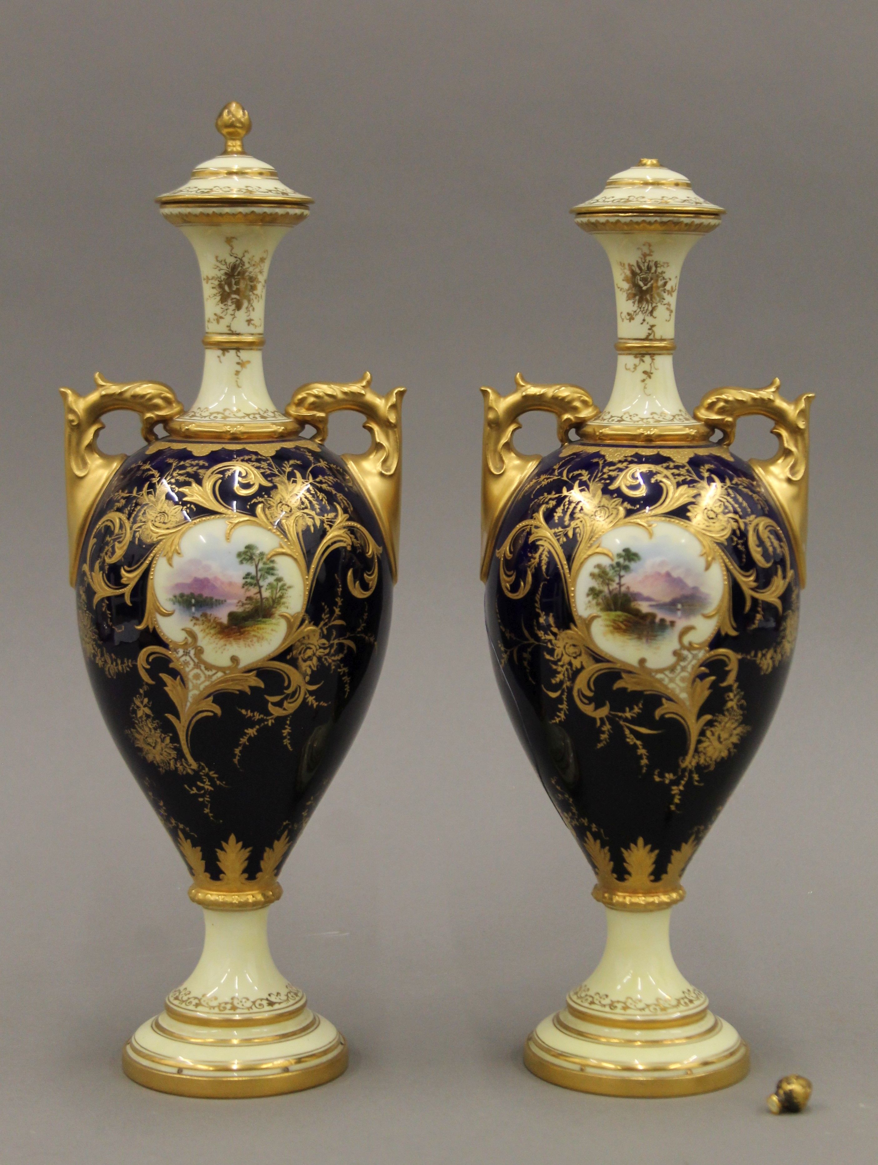 A pair of Coalport porcelain lidded vases. 33 cm high.