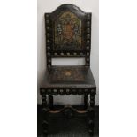 A pair of leather upholstered chairs decorated with heraldic crests.