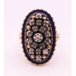 An antique 18 ct gold, blue enamel and diamond ring. Ring size M.