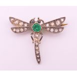A small unmarked emerald and diamond dragonfly form brooch. 2 cm high, 2.5 cm wide. 1.