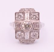 An 18 ct white gold Art Deco style diamond ring, the central stone spreading to approximately .