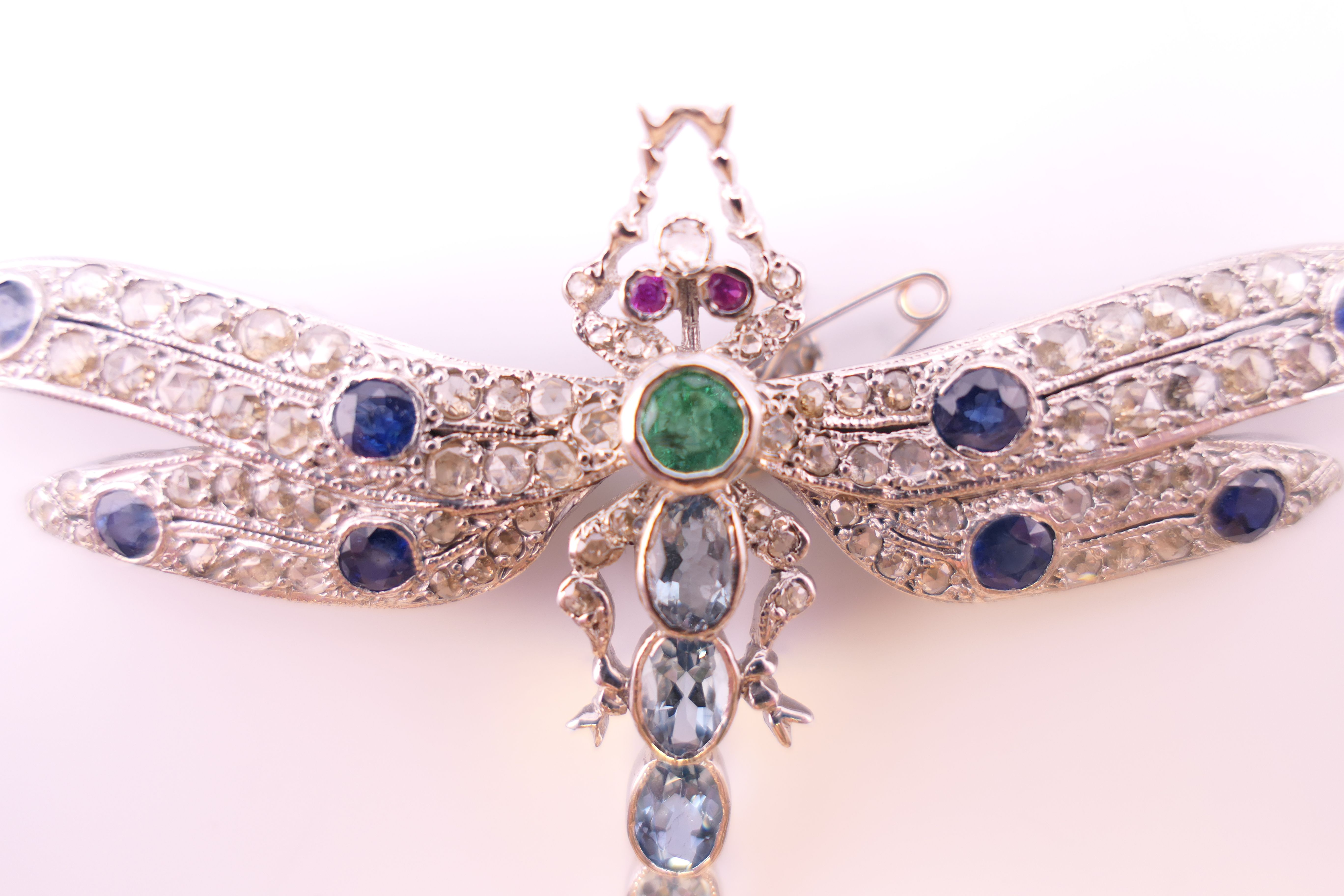 An unmarked 18 ct white gold dragonfly form diamond, sapphire, ruby, emerald and aquamarine brooch. - Image 3 of 11