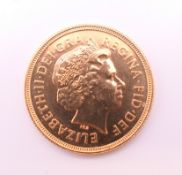 A 2002 gold sovereign, uncirculated.