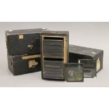 Four boxes of antique lantern slides.