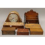 A mantle clock, a desk stand and various wooden boxes.