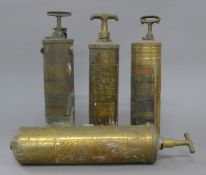 Four vintage American fire extinguishers.