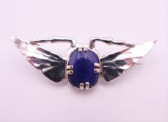A silver bug form brooch with lapis body. 5 cm wide.