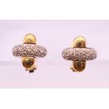 A pair of 18 ct gold and diamond earrings. 1.5 x 1.5 cm. 14.2 grammes total weight.