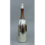 A silver plated champagne bottle form cocktail shaker. 37 cm high.