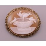 An unmarked yellow metal, probably gold, framed cameo depicting Pliny's doves. 3.75 cm wide.