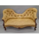 A Victorian rosewood framed camel back settee. Approximately 170 cm long.