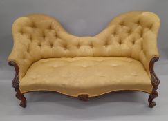 A Victorian rosewood framed camel back settee. Approximately 170 cm long.