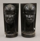 A pair of carved ebony bookends depicting tribal figures. 21.5 cm high.