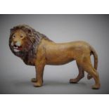 A cold painted bronze model of a lion. 9.5 cm long.