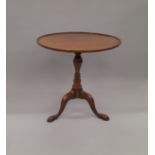 A reproduction mahogany tilt top tripod table. 68 cm diameter.