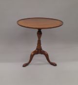 A reproduction mahogany tilt top tripod table. 68 cm diameter.